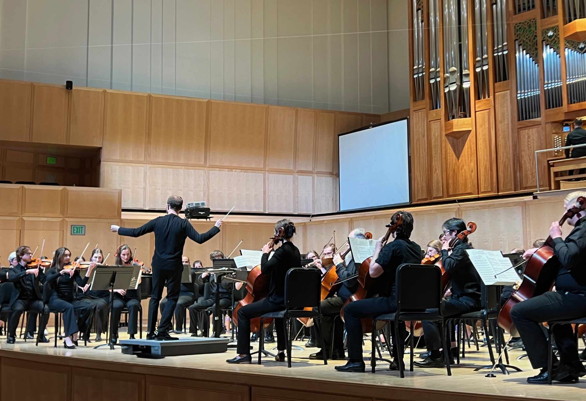 The Utah Medical Orchestra performing in a concert hall.