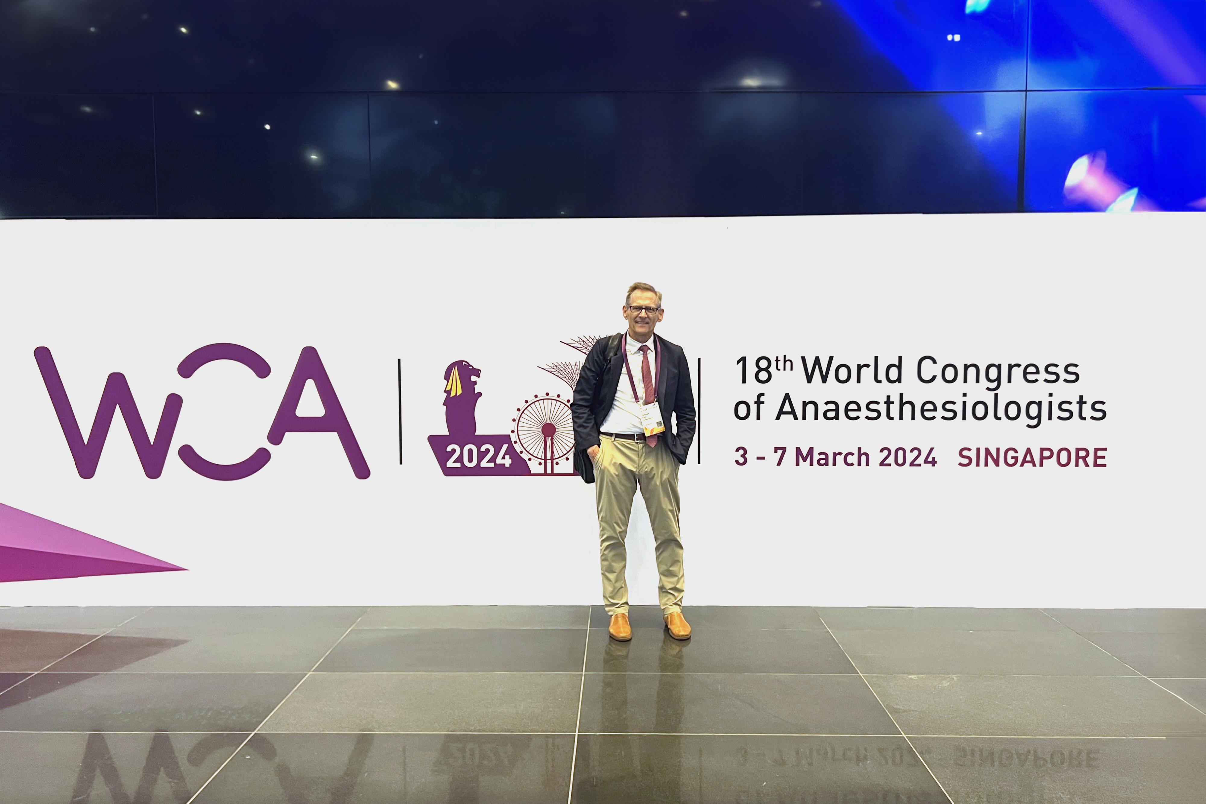 Dr. Egan in front of the 18th World Congress of Anesthesiologists sign in Singapore