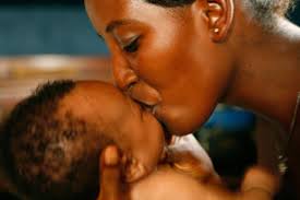 African Mother Kissing Infant