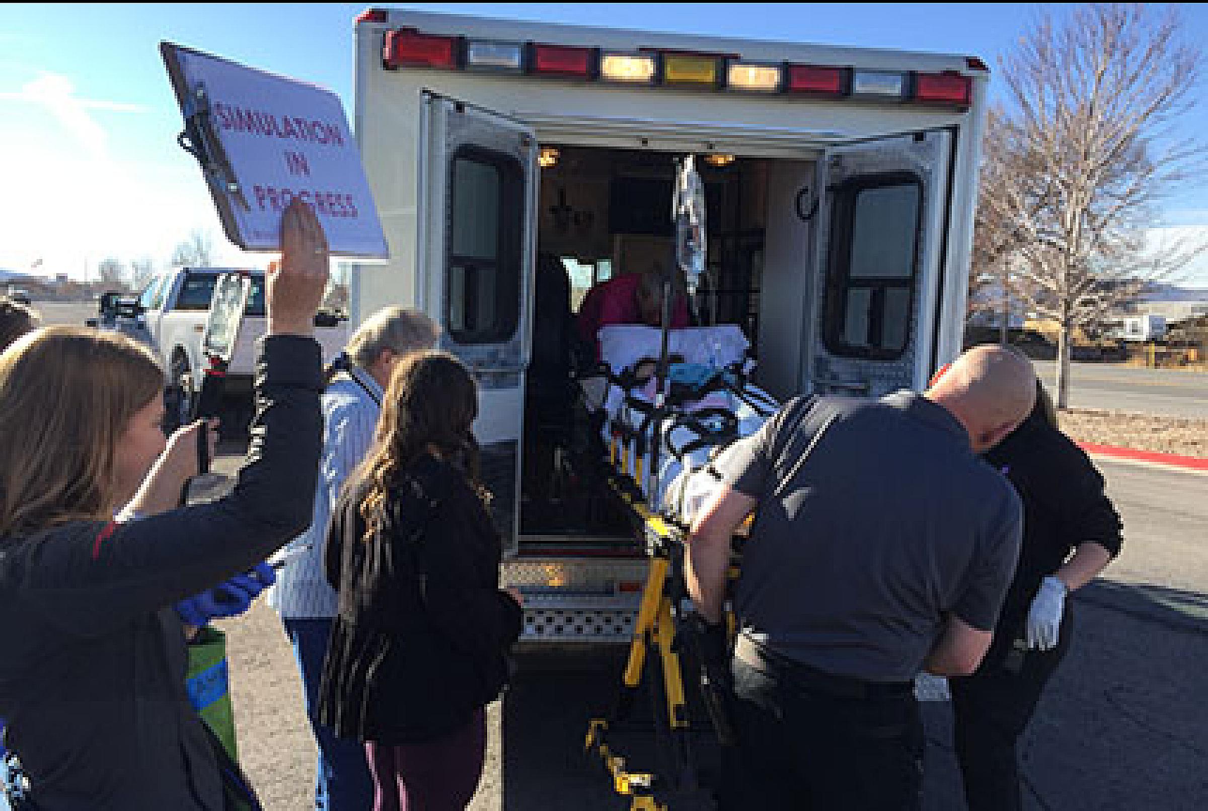 Patient being transferred into an ambulance, project arrise, department of family planning