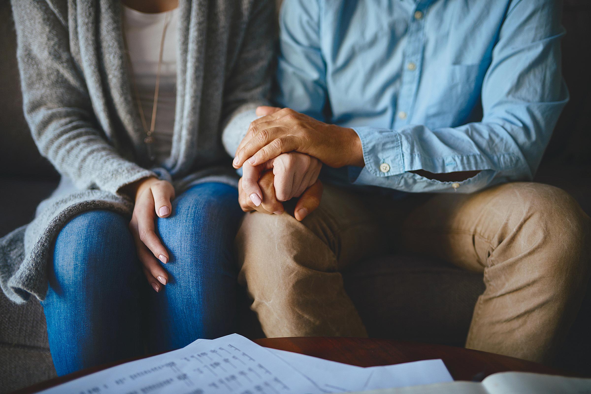 female and male couple holding hands