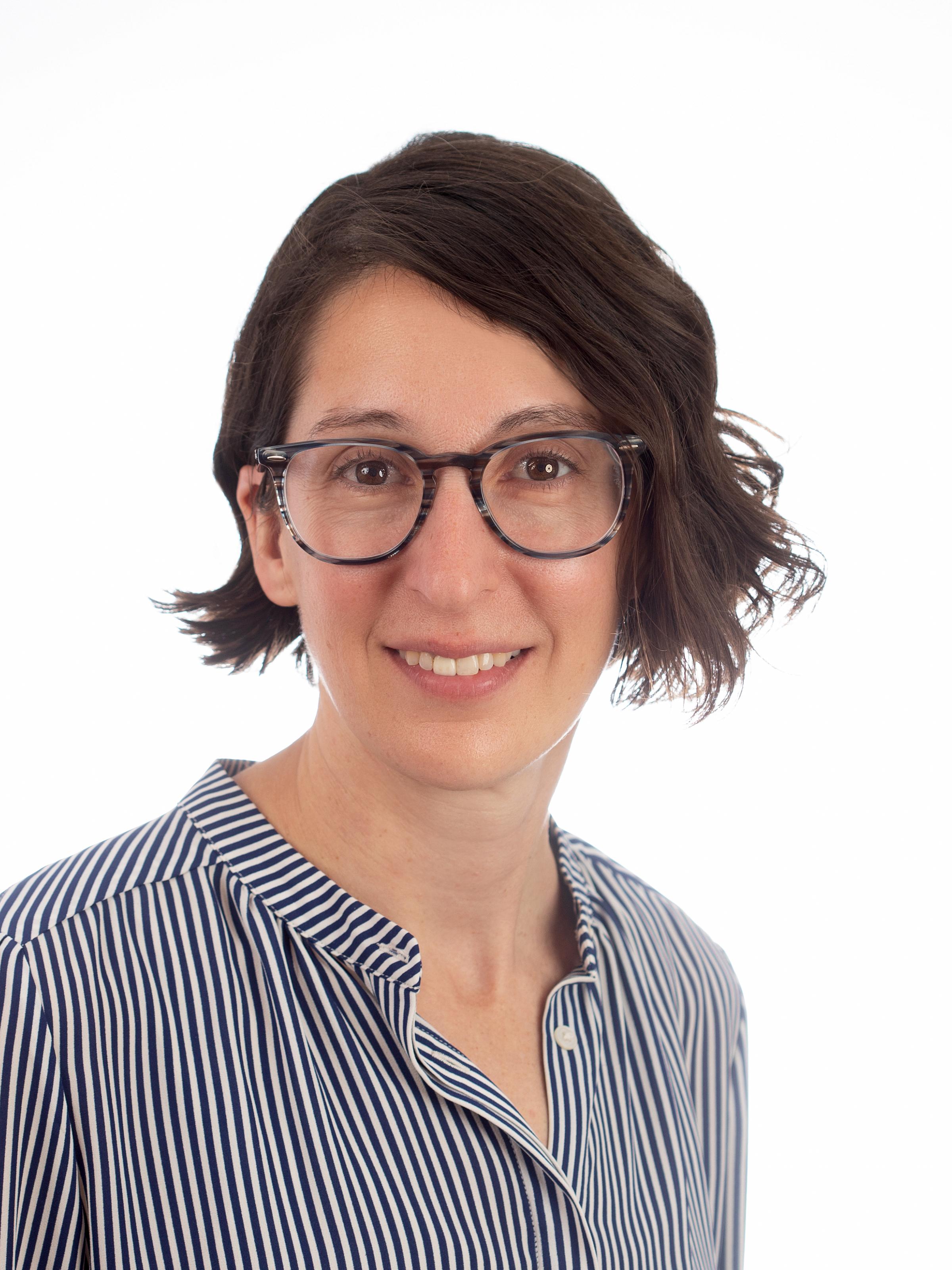 Kate Maurer headshot, short brown hair with glasses