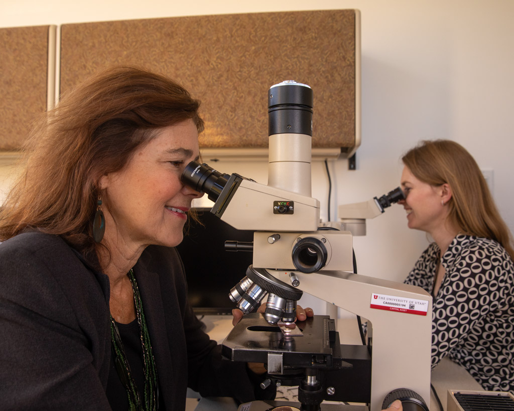 Docs looking in microscope