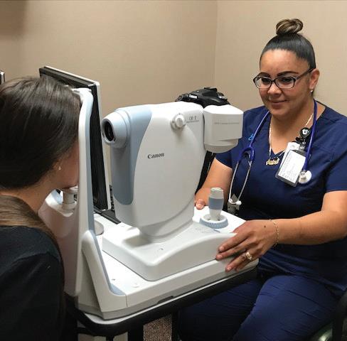 medical assistant performing eye exam