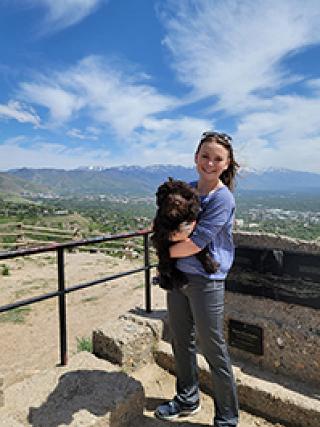 woman holding her dog on top of Ensign Peak in Salt Lake City, Utah