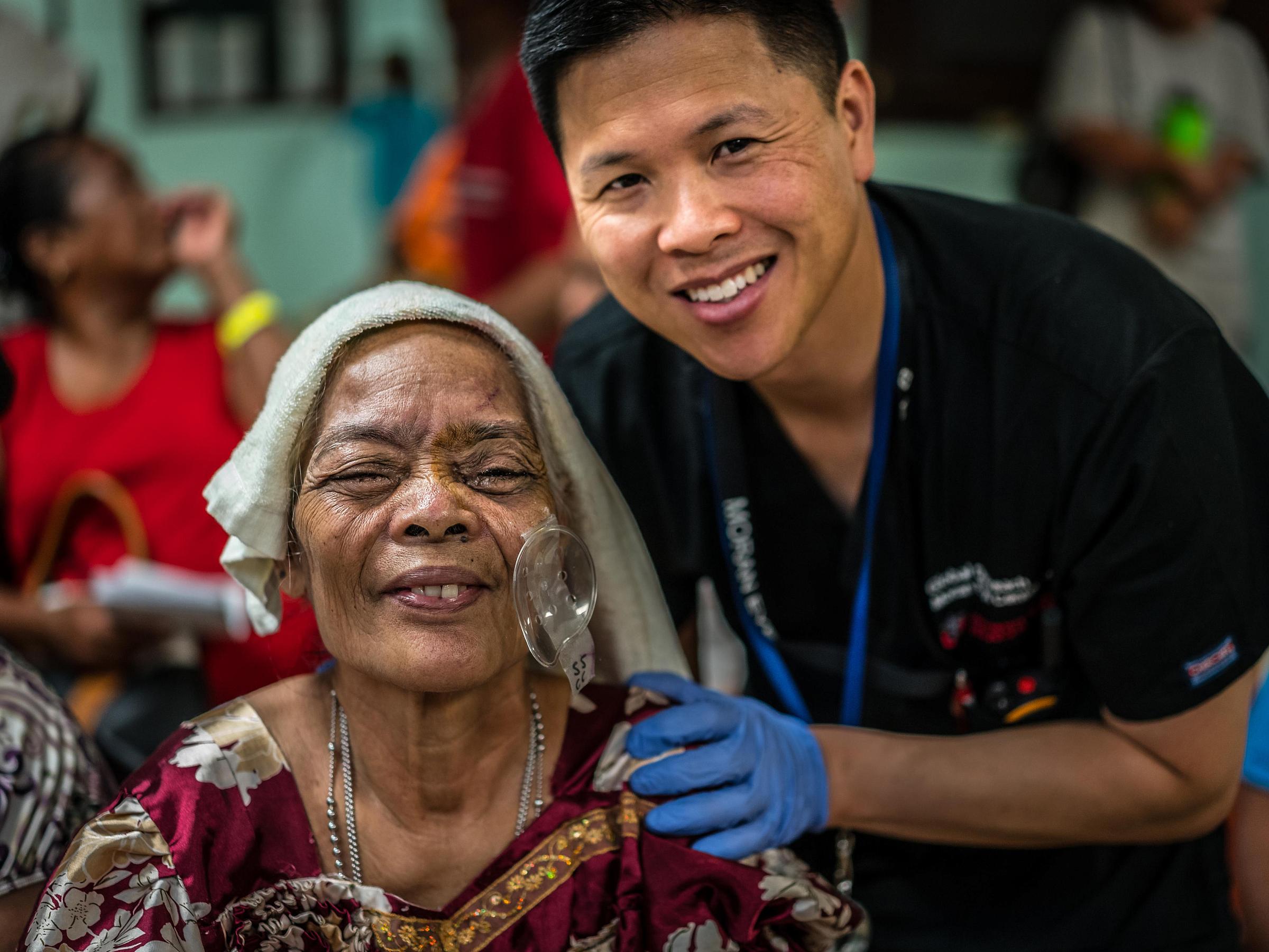 Dr. Craig Chaya with a patient in Micronesia