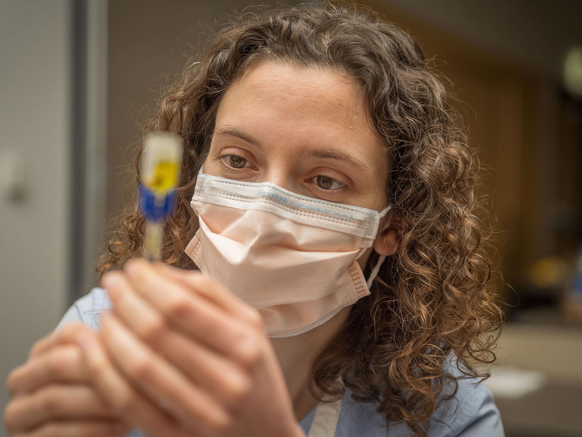 A resident performs research in a lab.