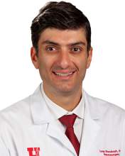 Loay Shoubash wearing a white suit and tie