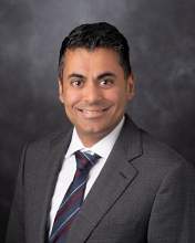 Professional photo of Amol Ghia wearing a suit and tie