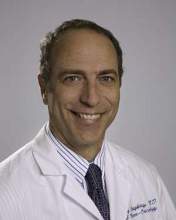 Professional photo of Timothy Cloughesy wearing a white coat