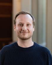 Professional photo of Frank Szulzewsky wearing a blue sweater