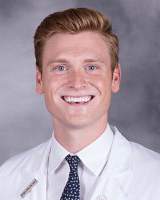 Phillip Johansen wearing a white coat and tie