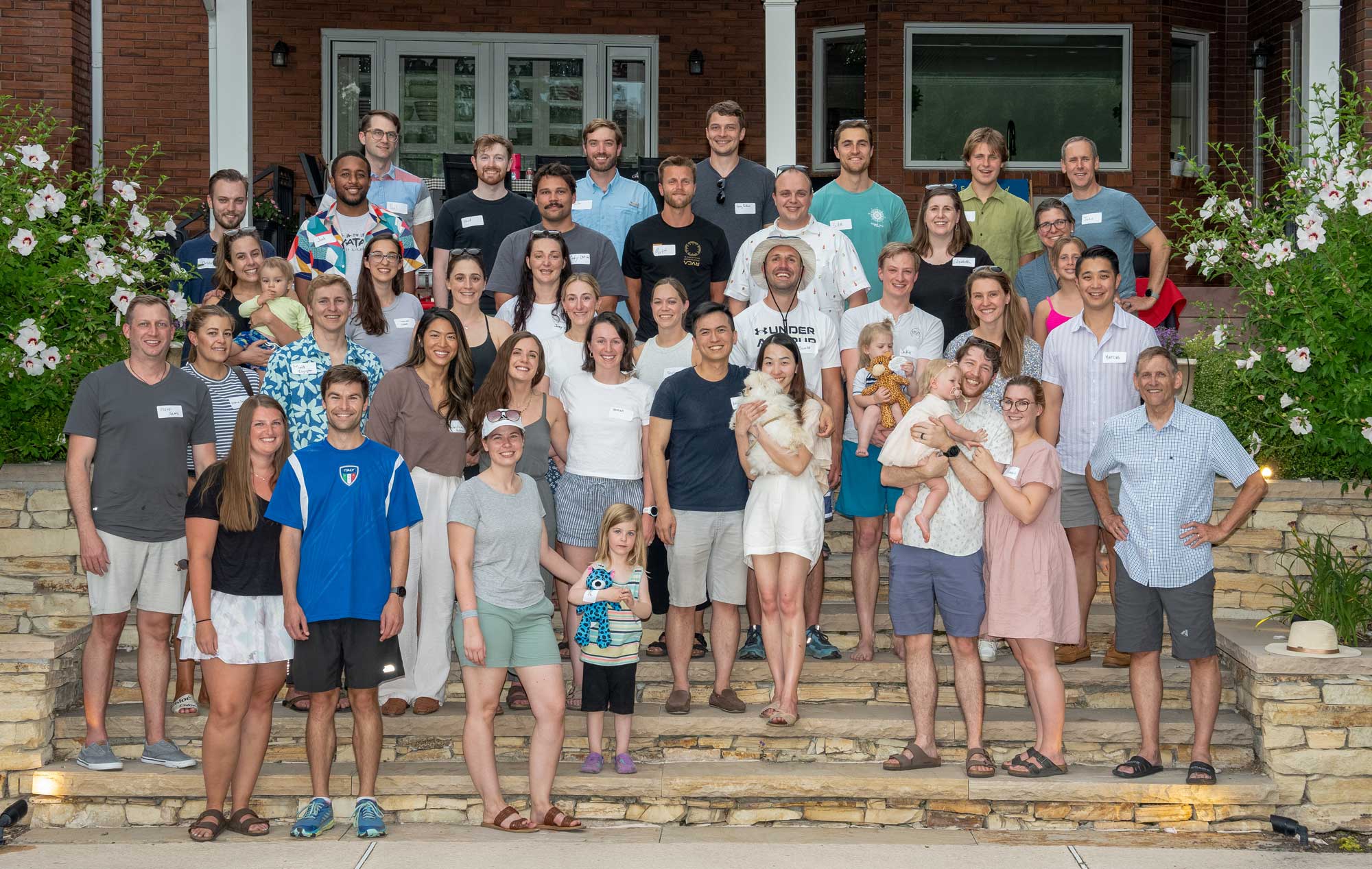 People gathered together for a group photo at a barbecue. 