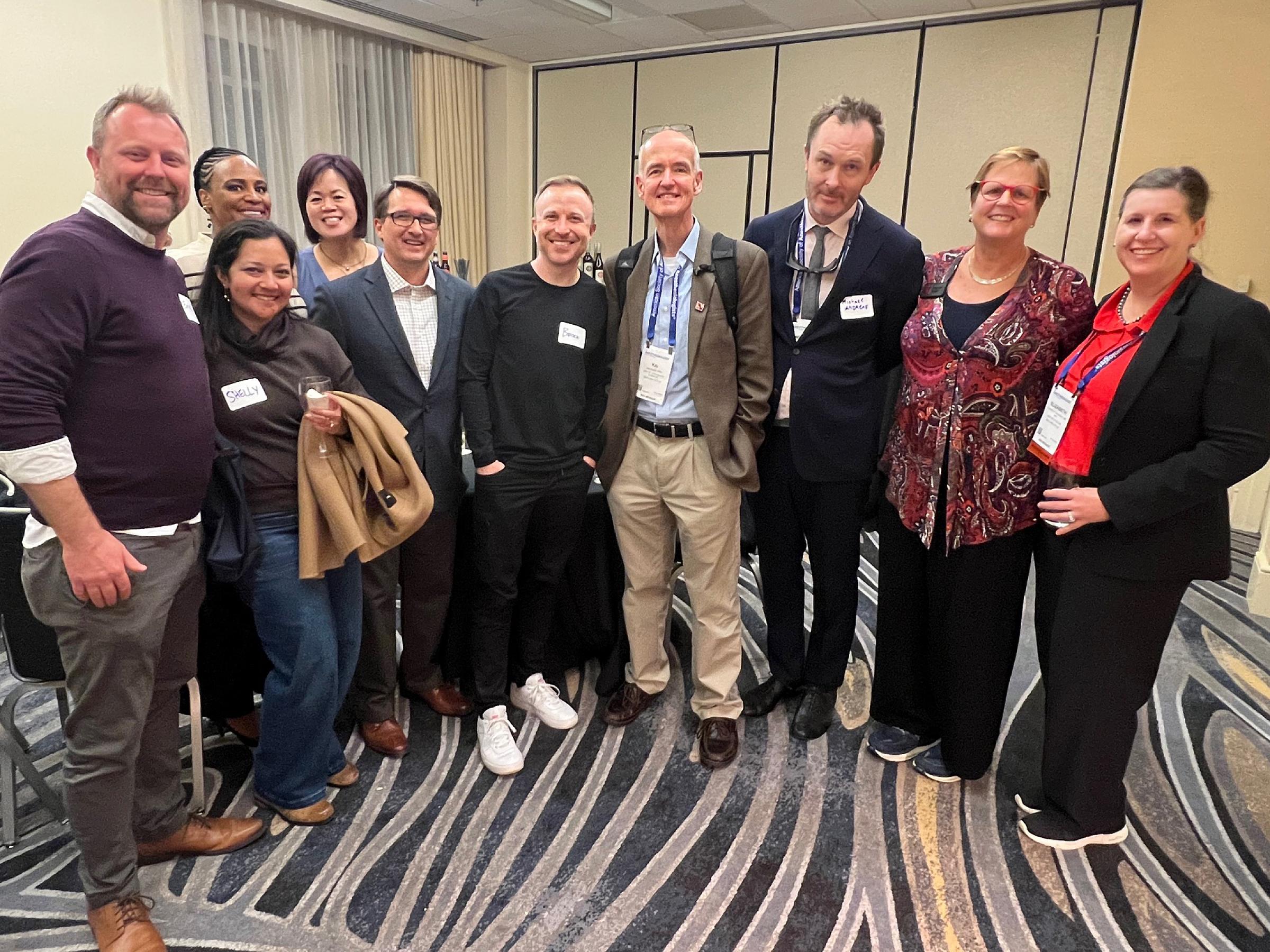 Ten people gathering together for a reunion during the 2024 ASA conference.
