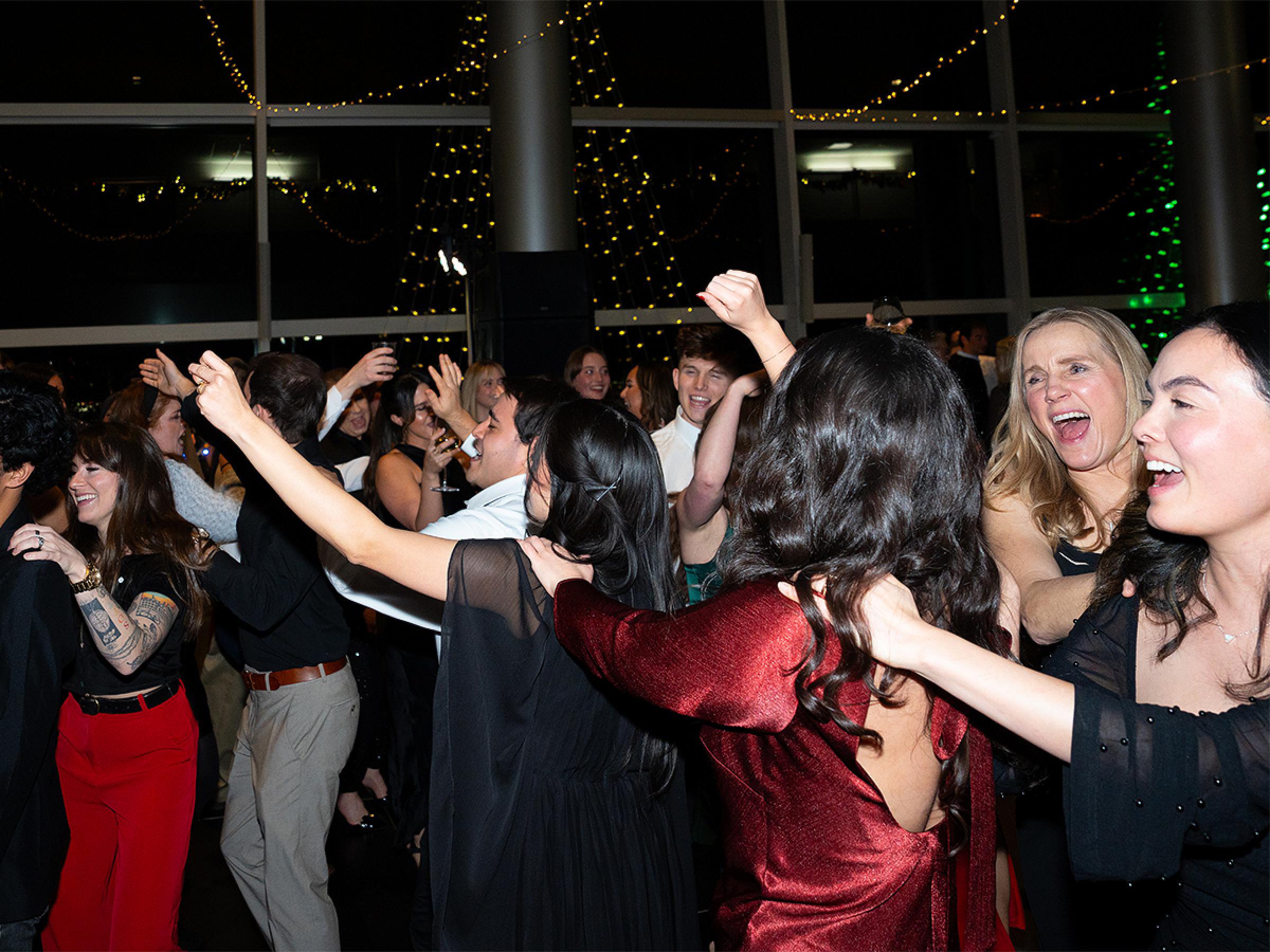 Lots of people out on the dance floor enjoying themselves. 