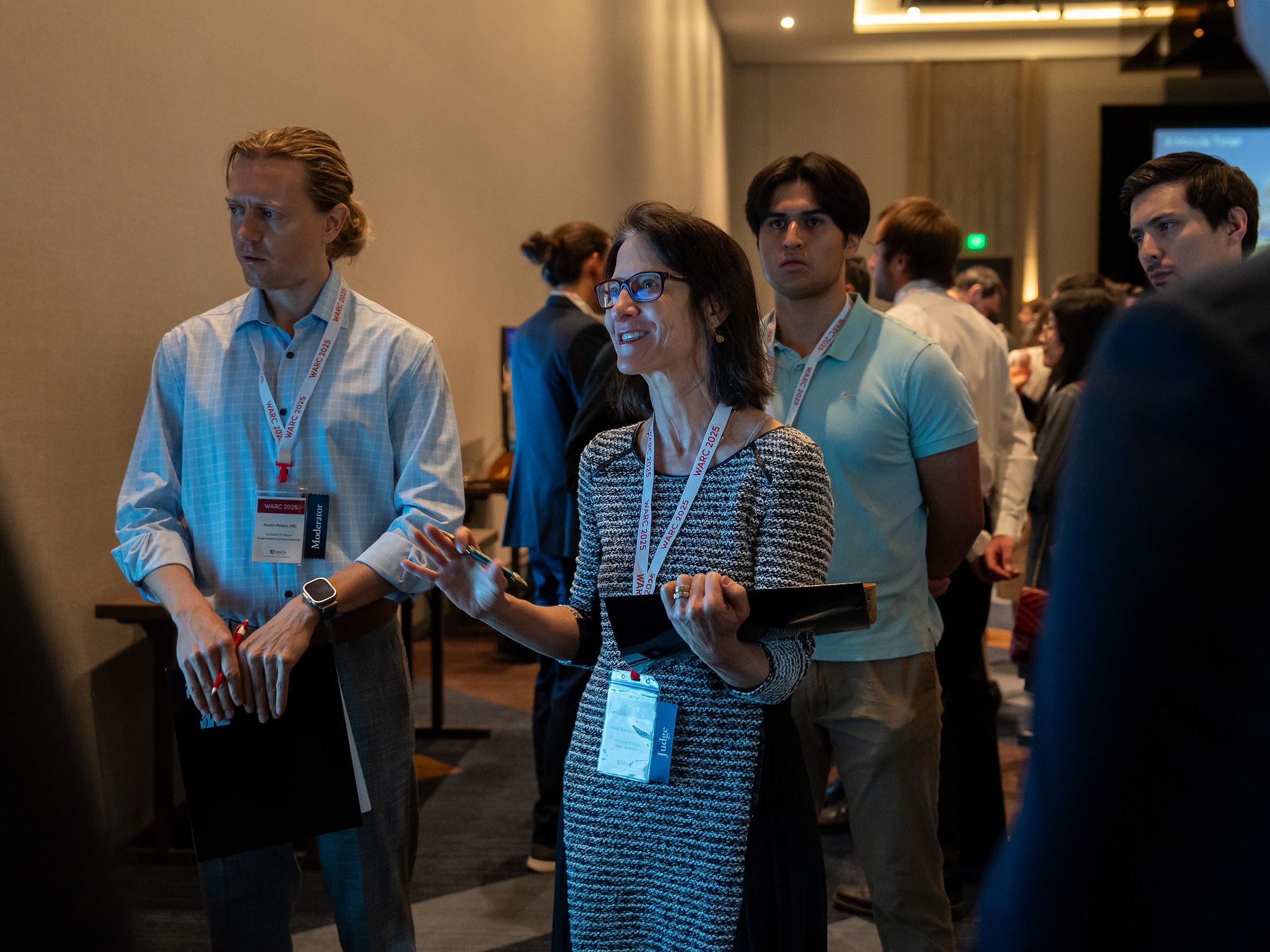 Three WARC poster judges react to one of the presentations.