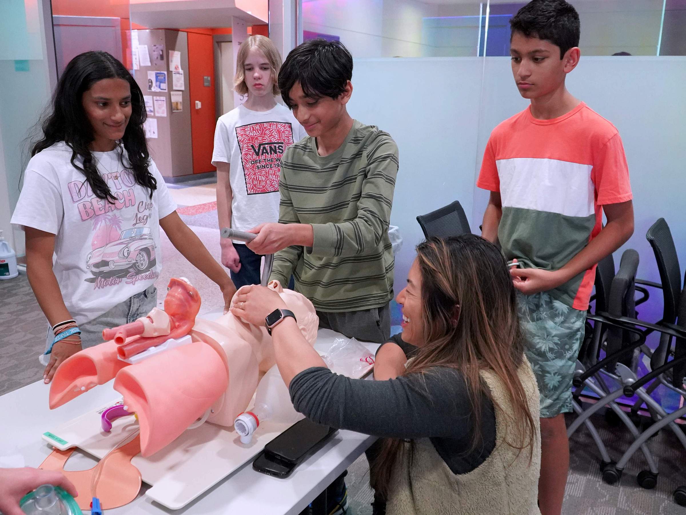 Dr. Ruefener showing students how to use a laryngoscope on a mannekin. 