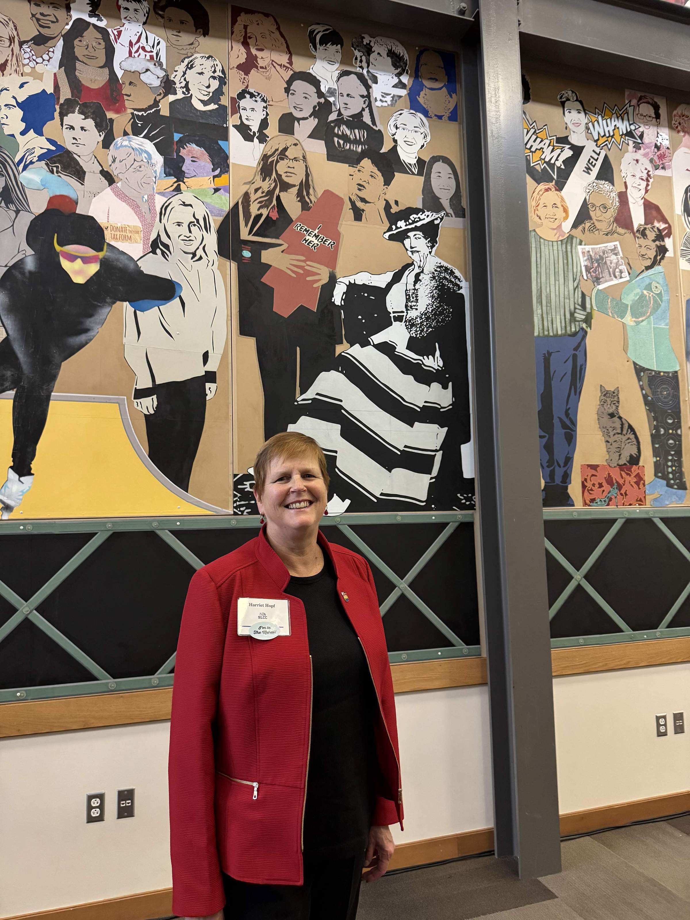 Dr. Harriet Hopf in front of the Utah Women Mural at Salt Lake City Community College