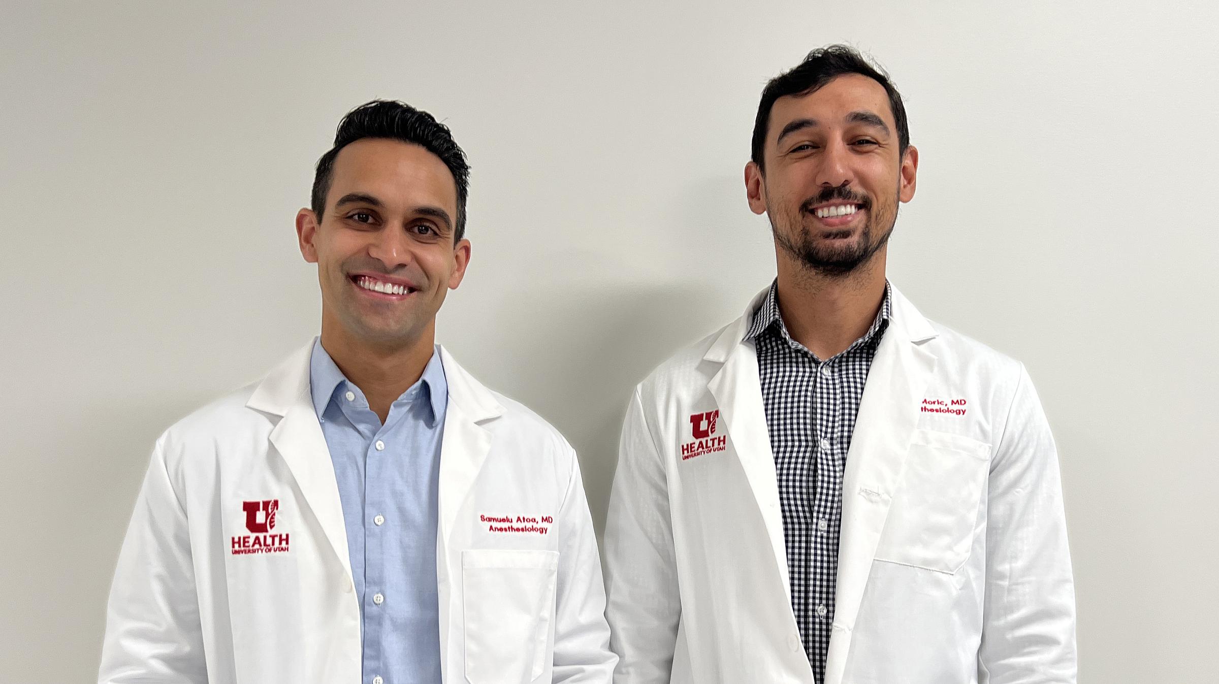 Dr. Atoa and Dr. Moric standing in front of a white background.