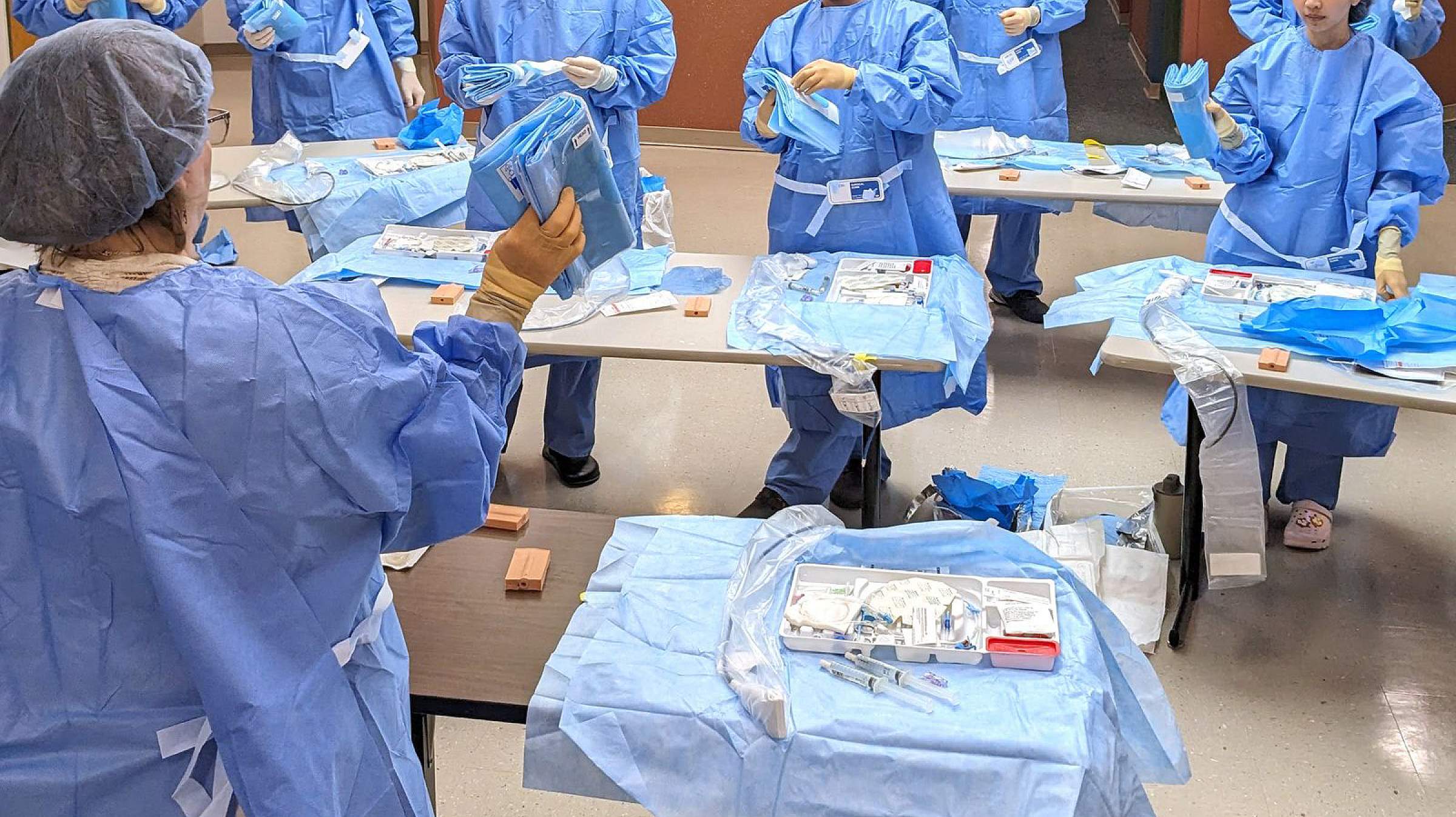 A faculty member instructing a group on central line placement. 