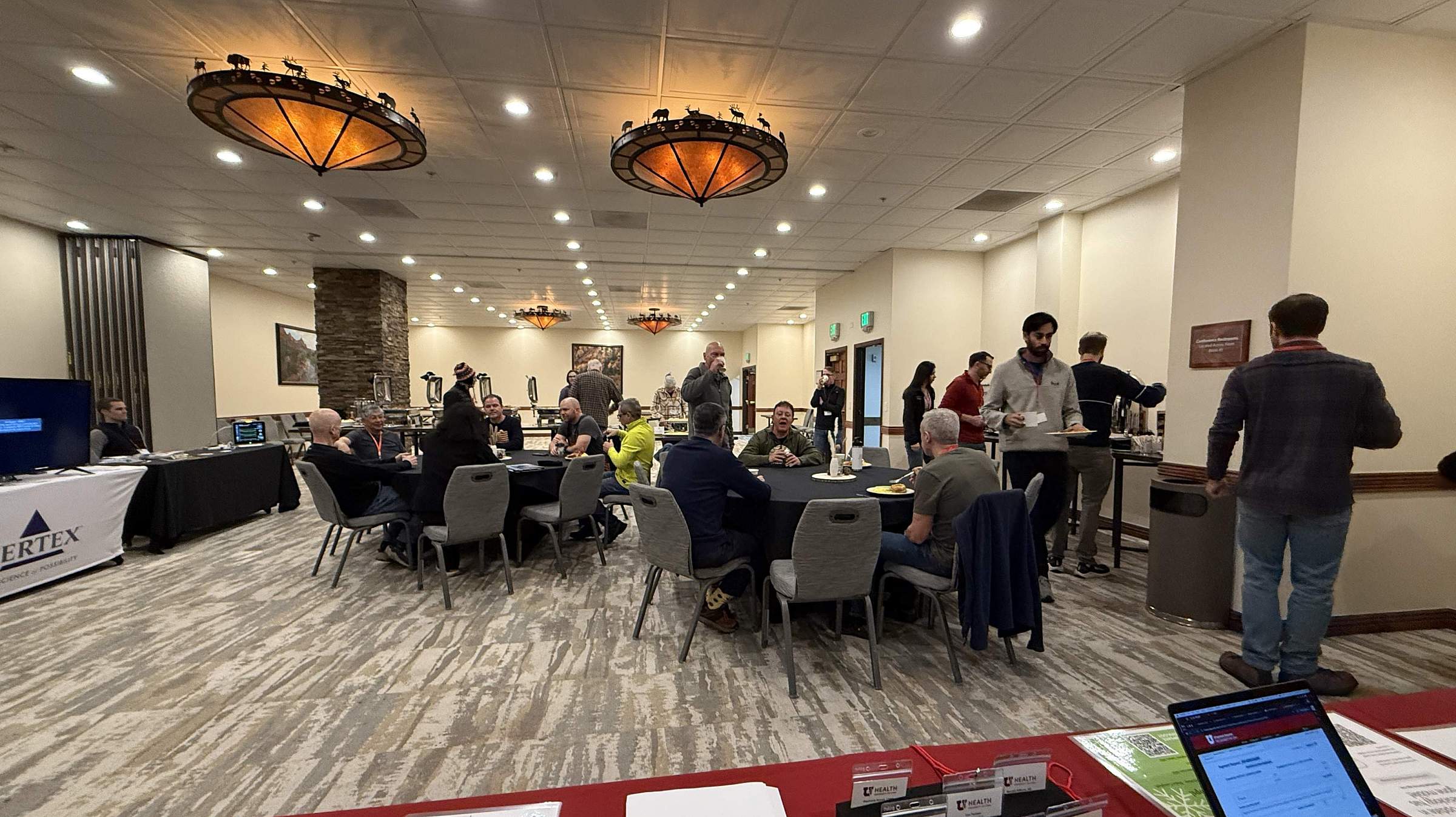 Attendees gather during a break to have coffee and snacks.