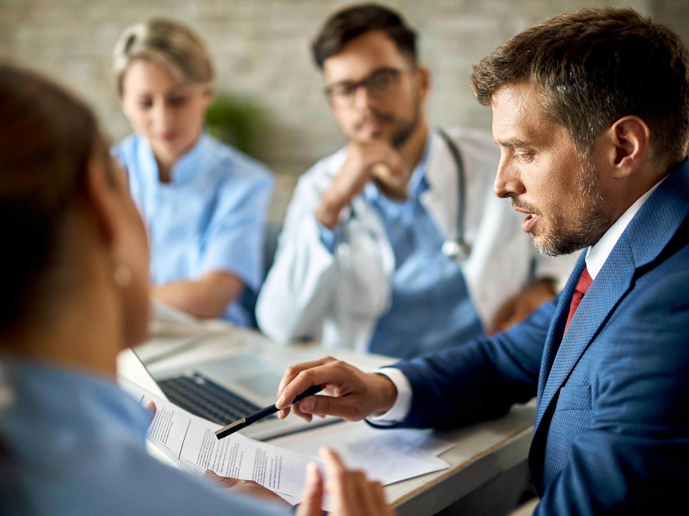 Business Man has a meeting with medical professionals